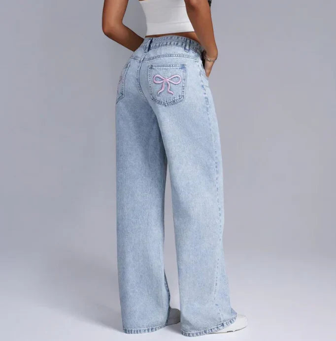 Stijlvolle denim jeans met wijde pijpen en roze strikdetails - Dames