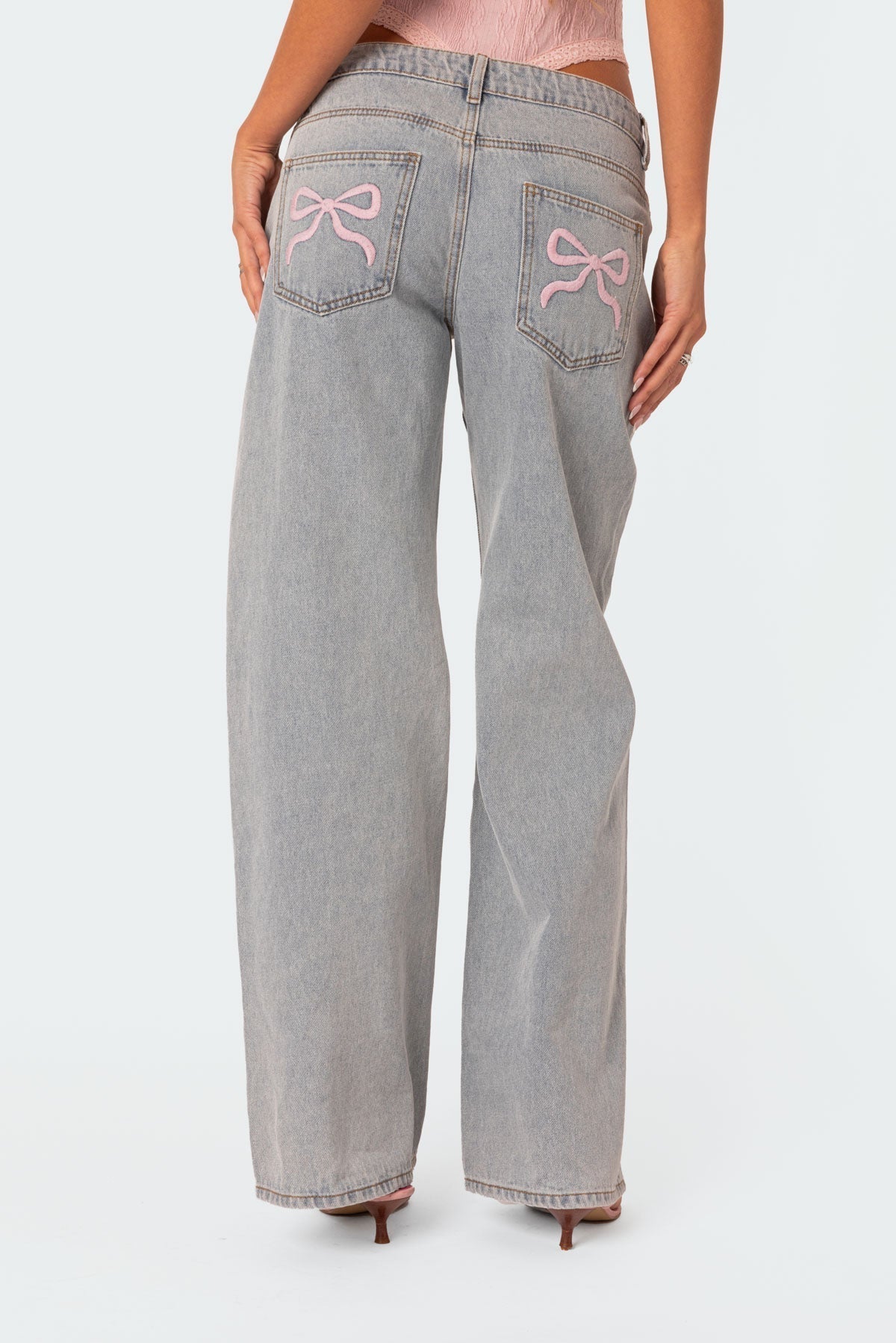 Stijlvolle denim jeans met wijde pijpen en roze strikdetails - Dames