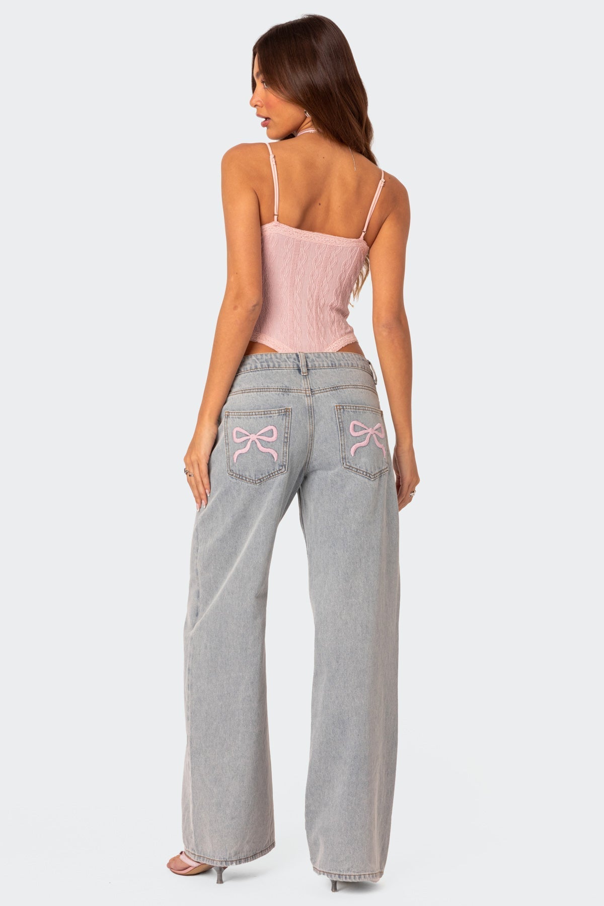 Stijlvolle denim jeans met wijde pijpen en roze strikdetails - Dames